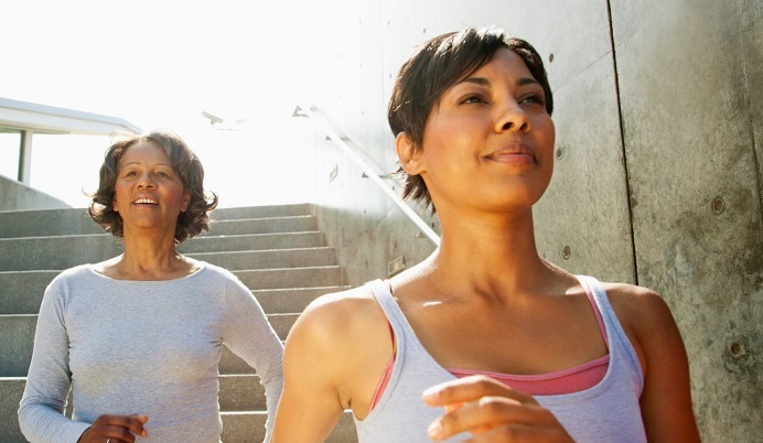 Adult daughter with mother exercising